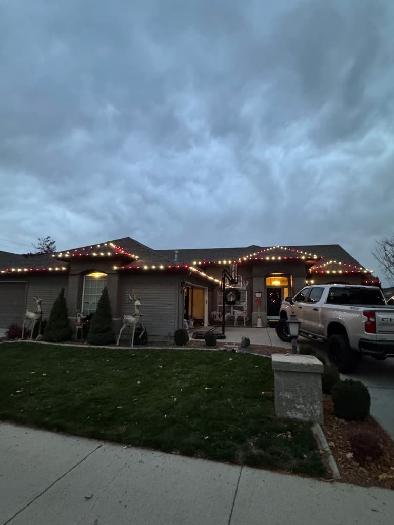 Boise home with completed roofline Christmas lights at dusk
